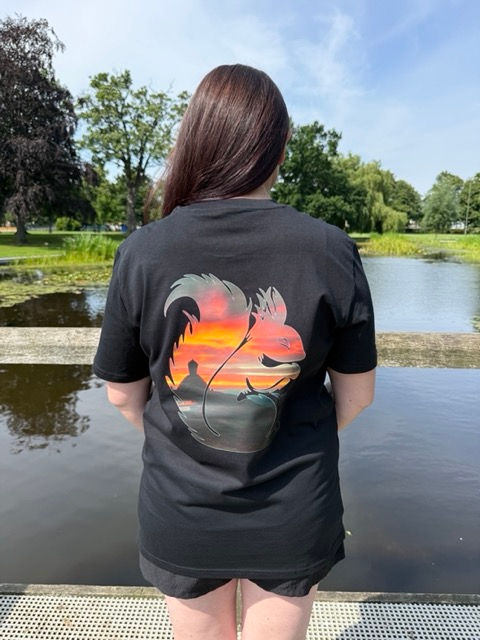 Woman with a Sunset Photo on the back of a black T Shirt
