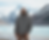 Thumbnail: Man standing in front of a lake and mountains wearing a white hat and a grey hoodie with  black design of a runner