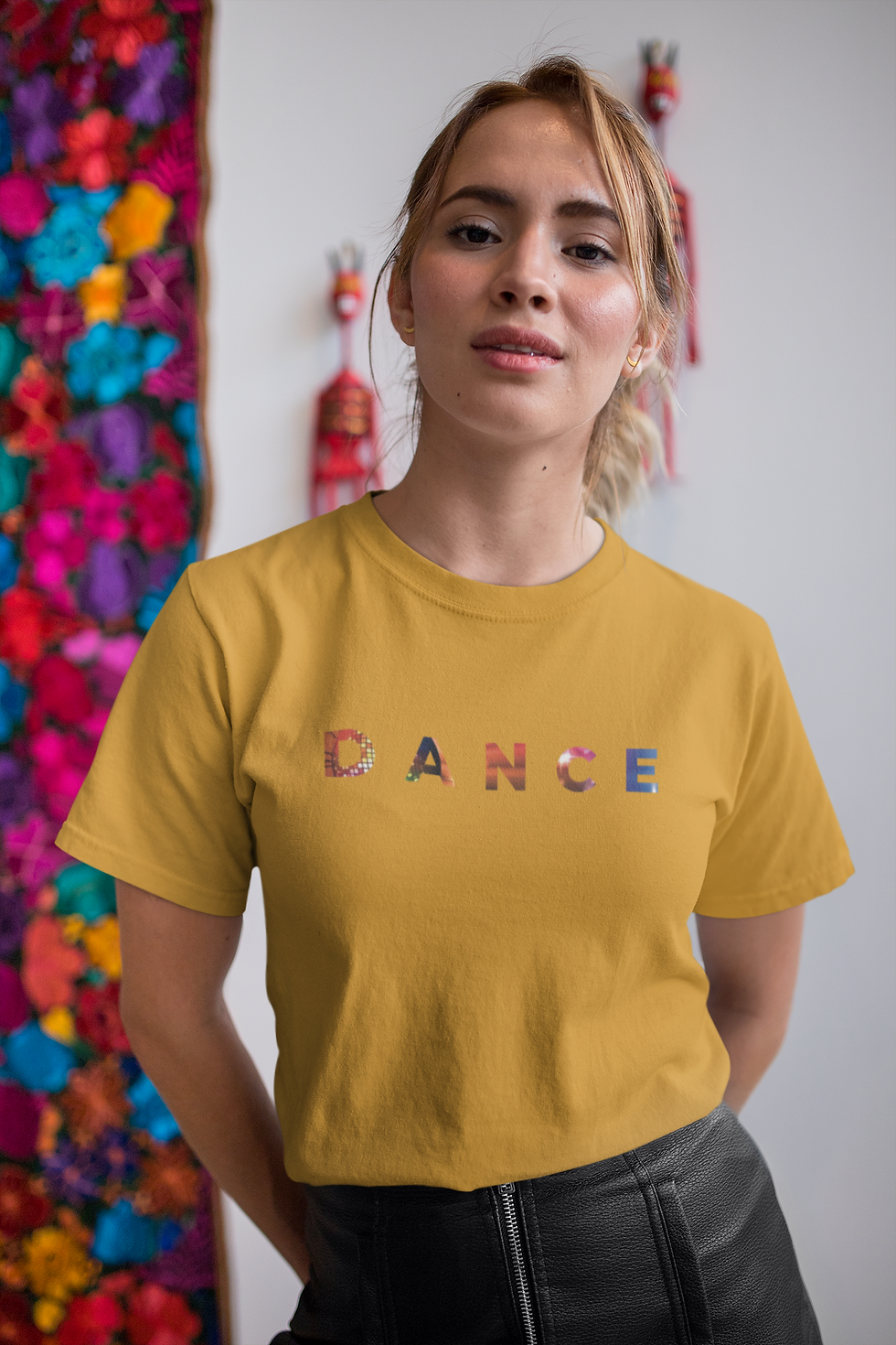 woman wearing a yellow t shirt with the word Dance on the front in bright colours