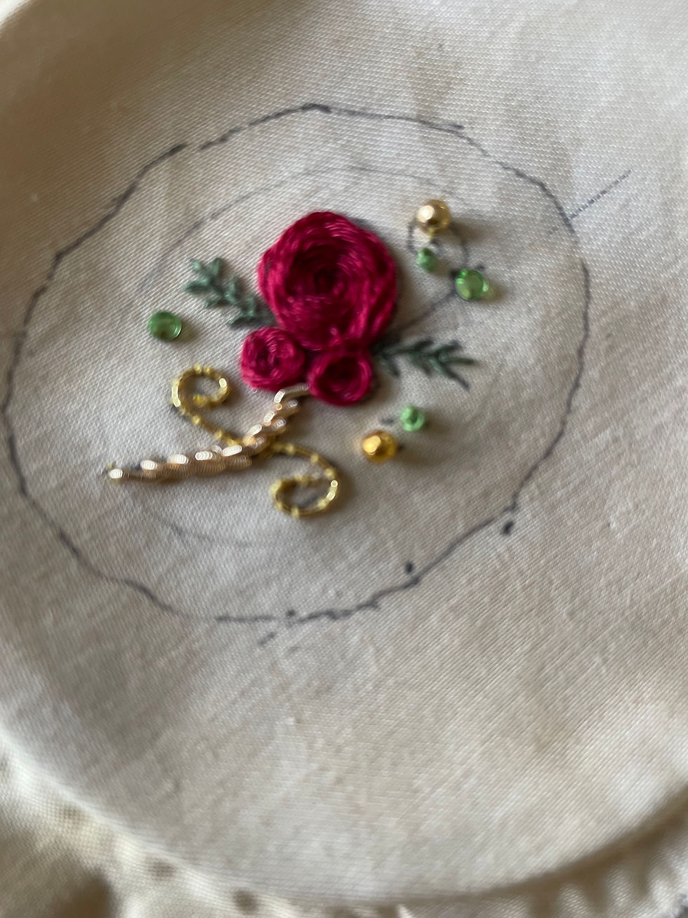 An embroidered rose with goldwork