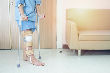patient with a brace using cruches