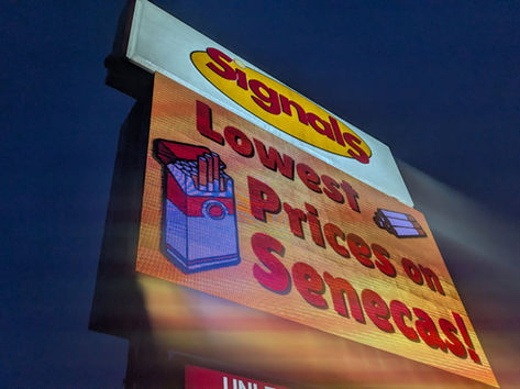 A sign giving off a bright spectrum of light.