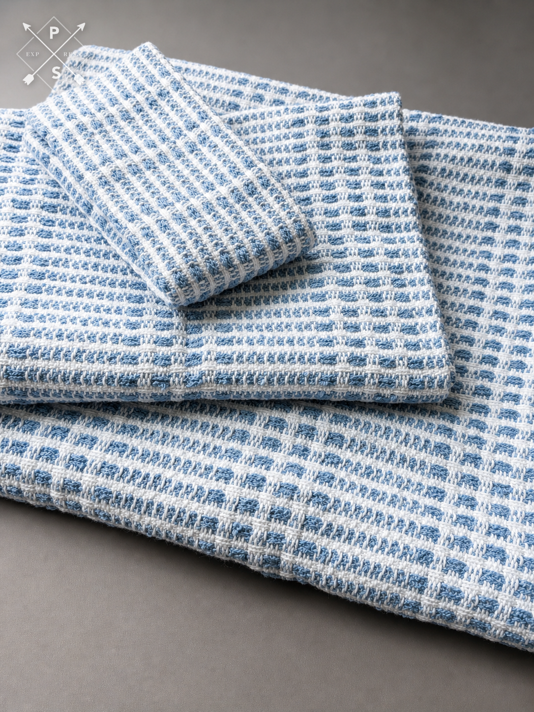 Handwoven cotton bathroom towel set showing washcloth, hand towel and bath sheet