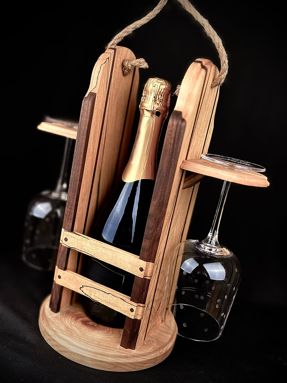 Thumbnail: Angled view of spalted maple and black walnut wine tote, highlighting the rich wood grains and craftsmanship. Features the wine glasses and bottle to portray its purpose.
