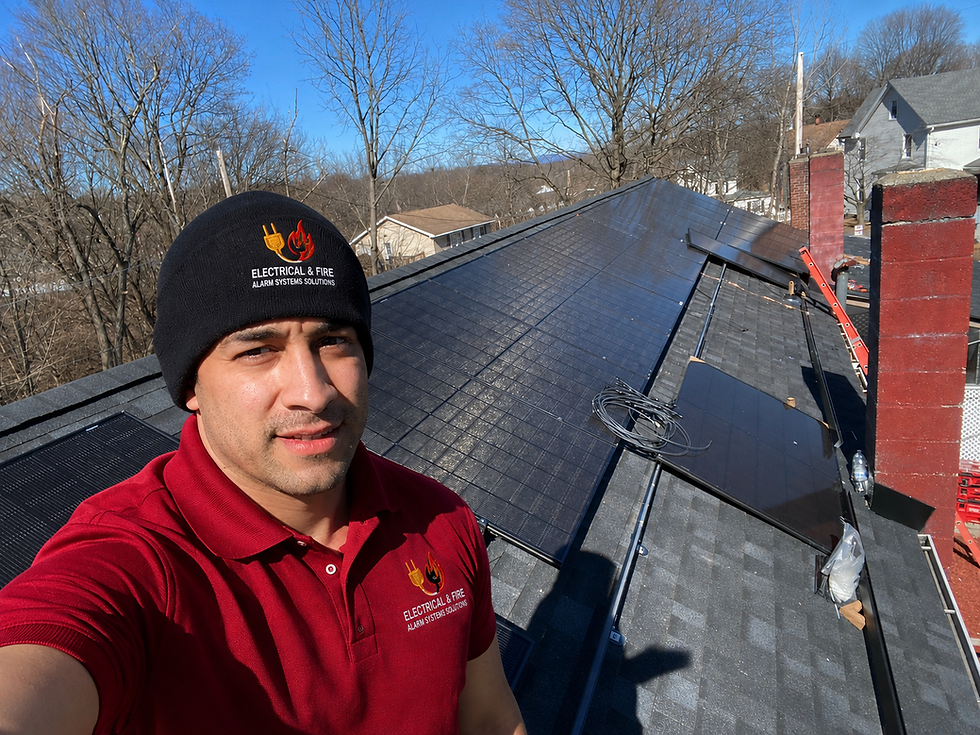 Technician providing electrical & fire system solutions on a roof.