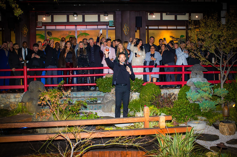 Robert Parks-Valletta speaking to a crowd at the Staycation Red Carpet Event in Los Angeles