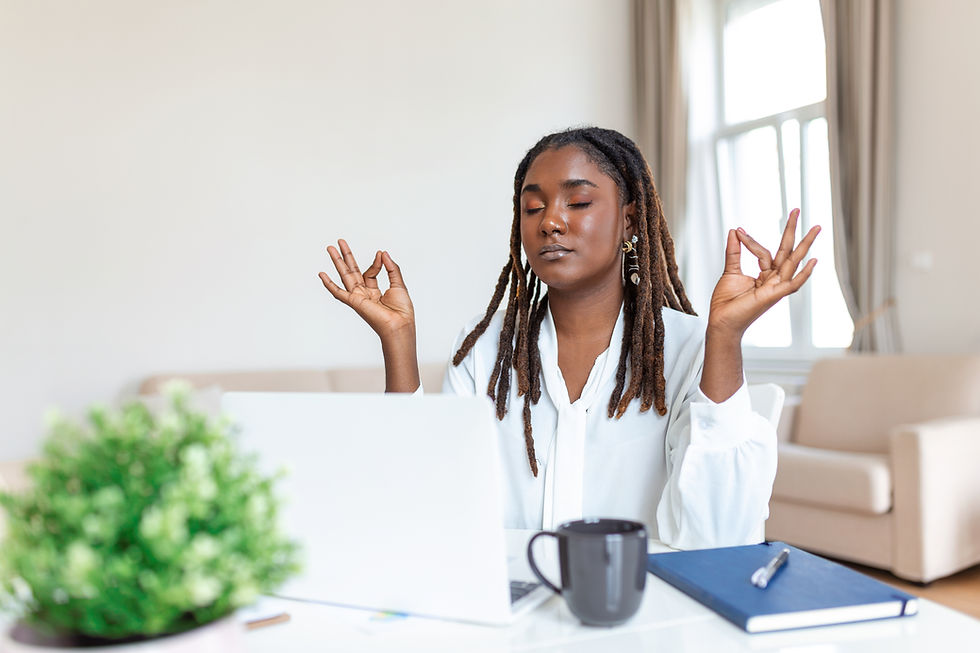 Hand wearing black beads in a relaxed pose, against a blurred green background, suggesting calmness and meditation.