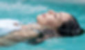 Woman floating on her back in a mineral water pool at a spa on Miracle Hill