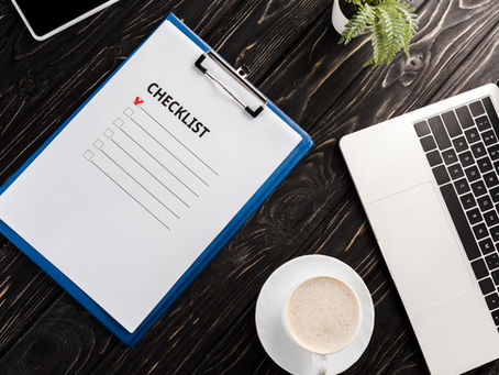 Organized workspace with laptop and checklist.