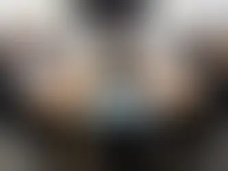 Boardroom meeting with professionals seated around a long conference table, engaged in discussion.