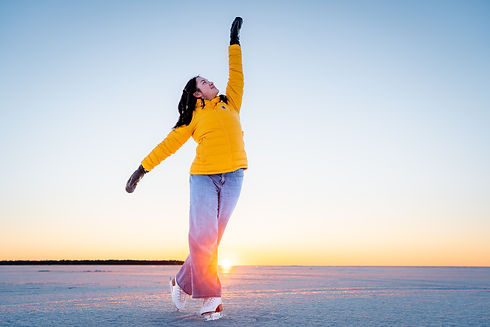 Angelina Huang poses on wild ice with the sunset in the background