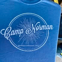Blue t-shirt that says "Camp Norman"