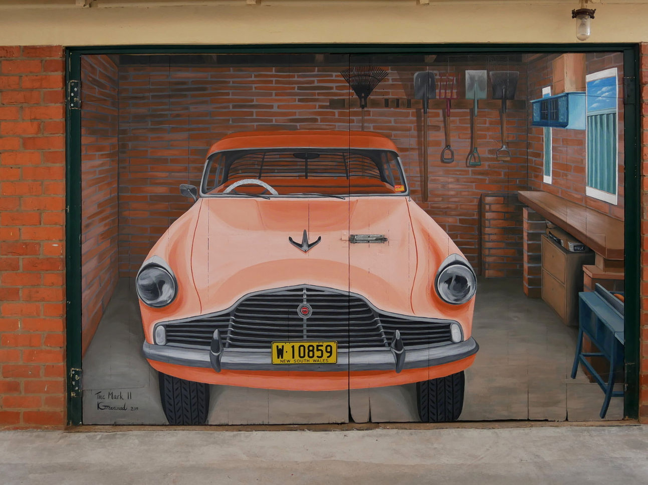 An artistic representation of an old car on a garage door painted in 3D, titled "The Mark 2" by Kristina Greenwood Art.