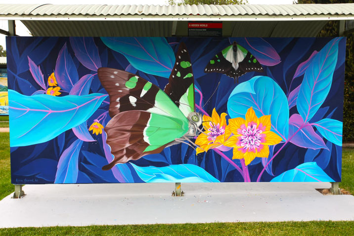 A large butterfly mural under a bus shelter, highlighting creativity at Mural Fest in Sheffield, Tasmania.