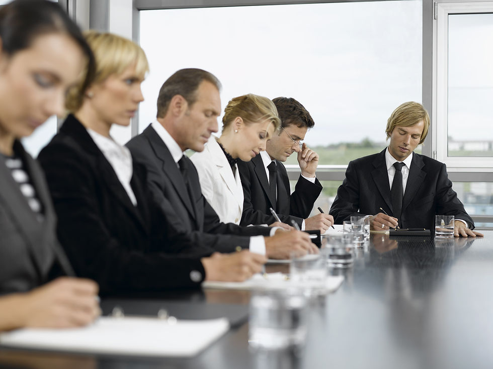 a group of employees at the meeting table