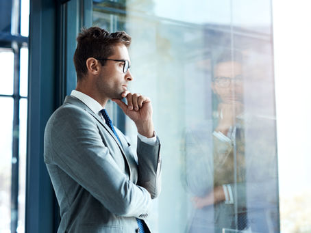 An executive from senior management, lost in thought.