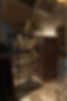 Champagne glasses on a black shelf with flowers, set in a dim room. A sign reads "Clink & Chat Connect." Warm, elegant ambiance.