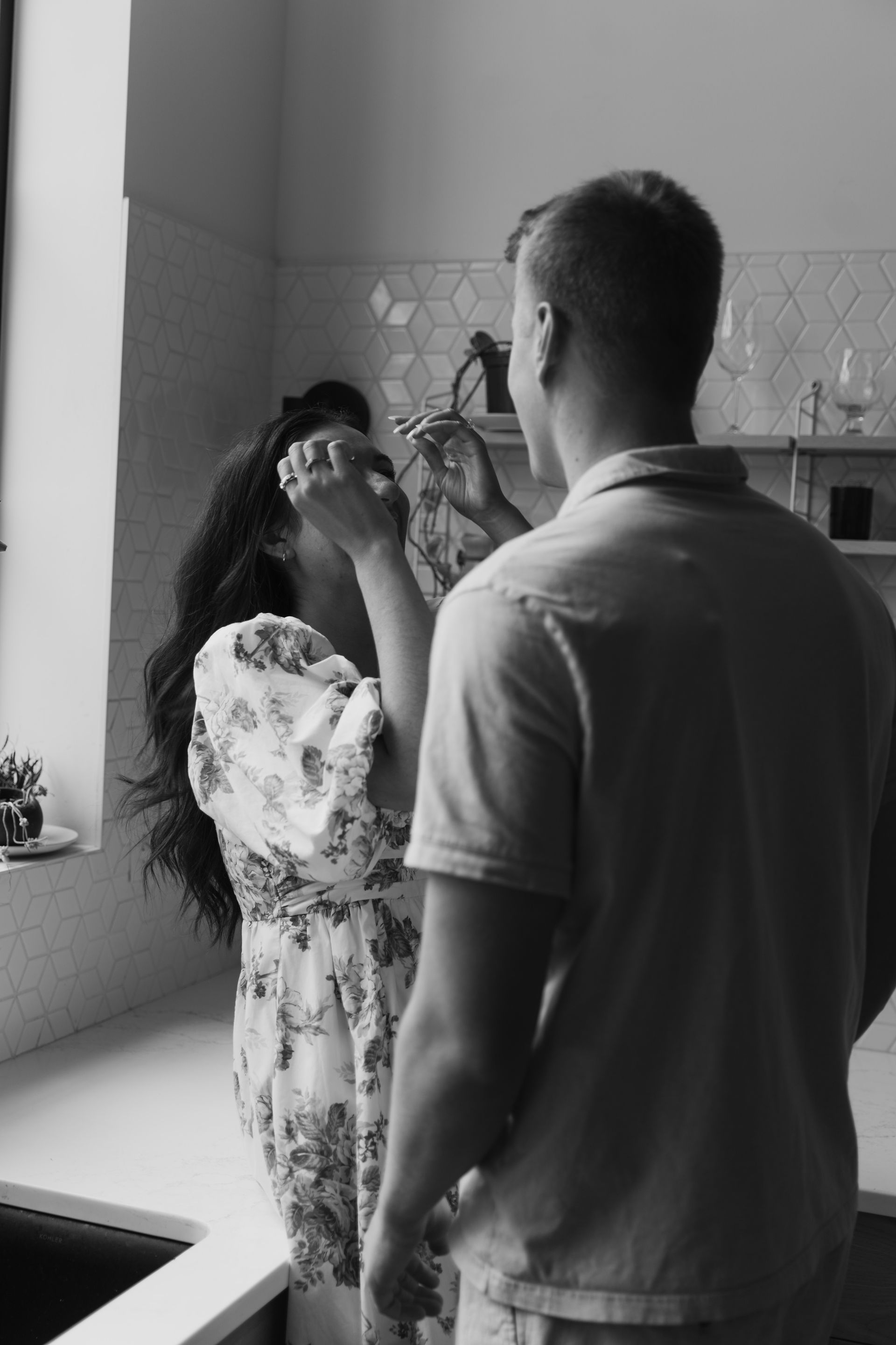 engaged couple in kitchen