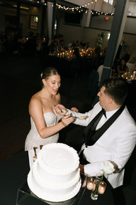 bride and groom feeding each other cake