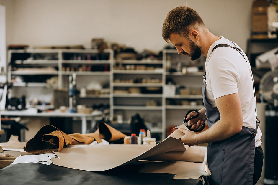 man-tailor-working-with-leather-fabric.jpg