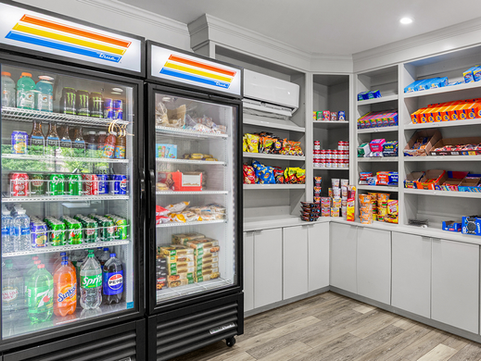 A Red Roof Inn marketplace with a drink cooler, and shelves of grab-and-go snacks.