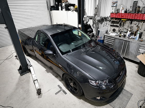Professional ceramic coating application completed on black performance sedan in Brisbane