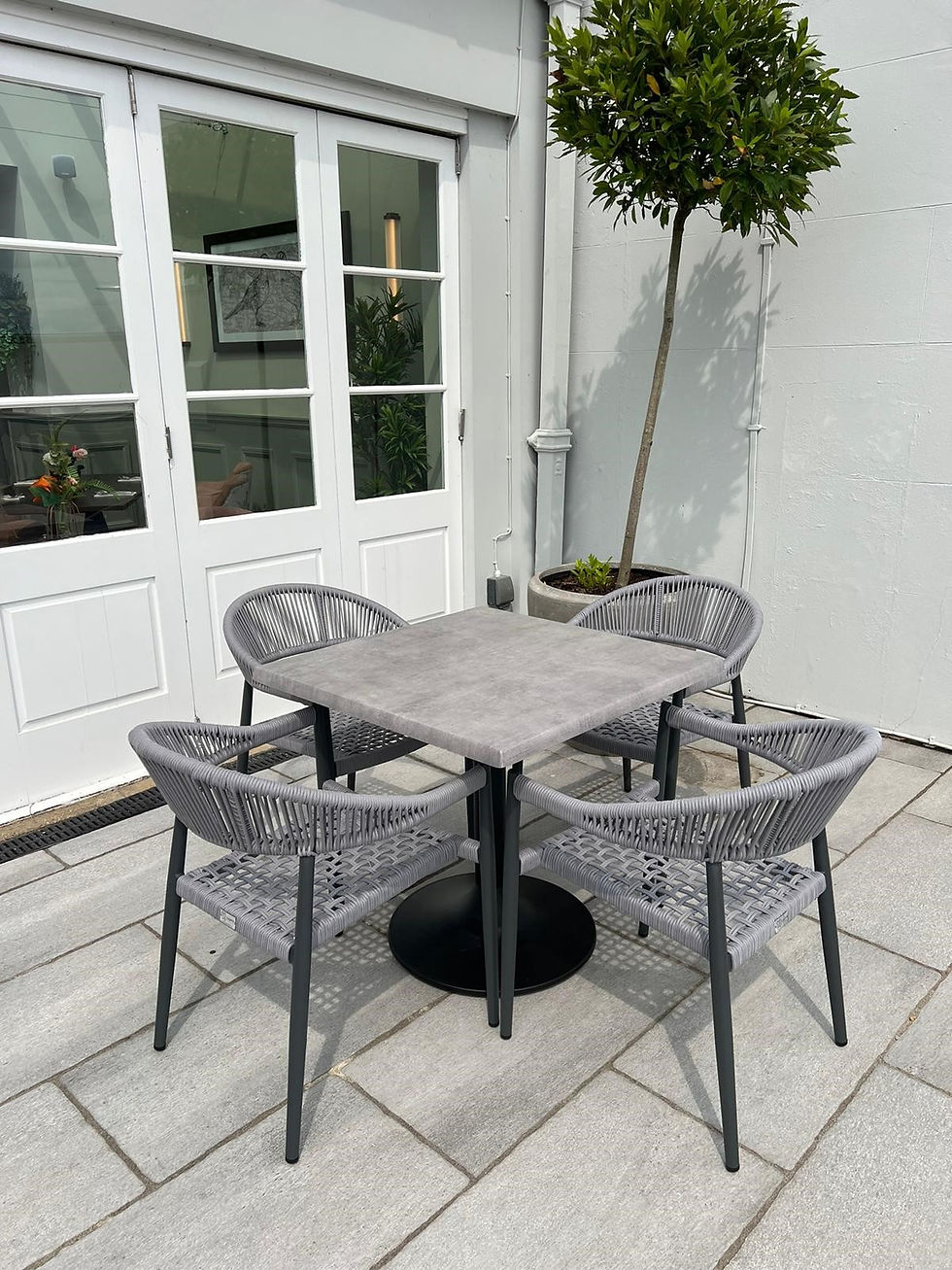 Thumbnail: Padstow Rope Stacking Armchair Grey with grey table on patio