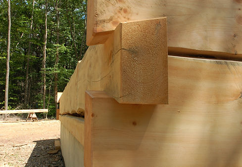 A close up of a few half dovetails on an unfinsihed log home.