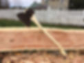 A hand hewn log with a broad ax.