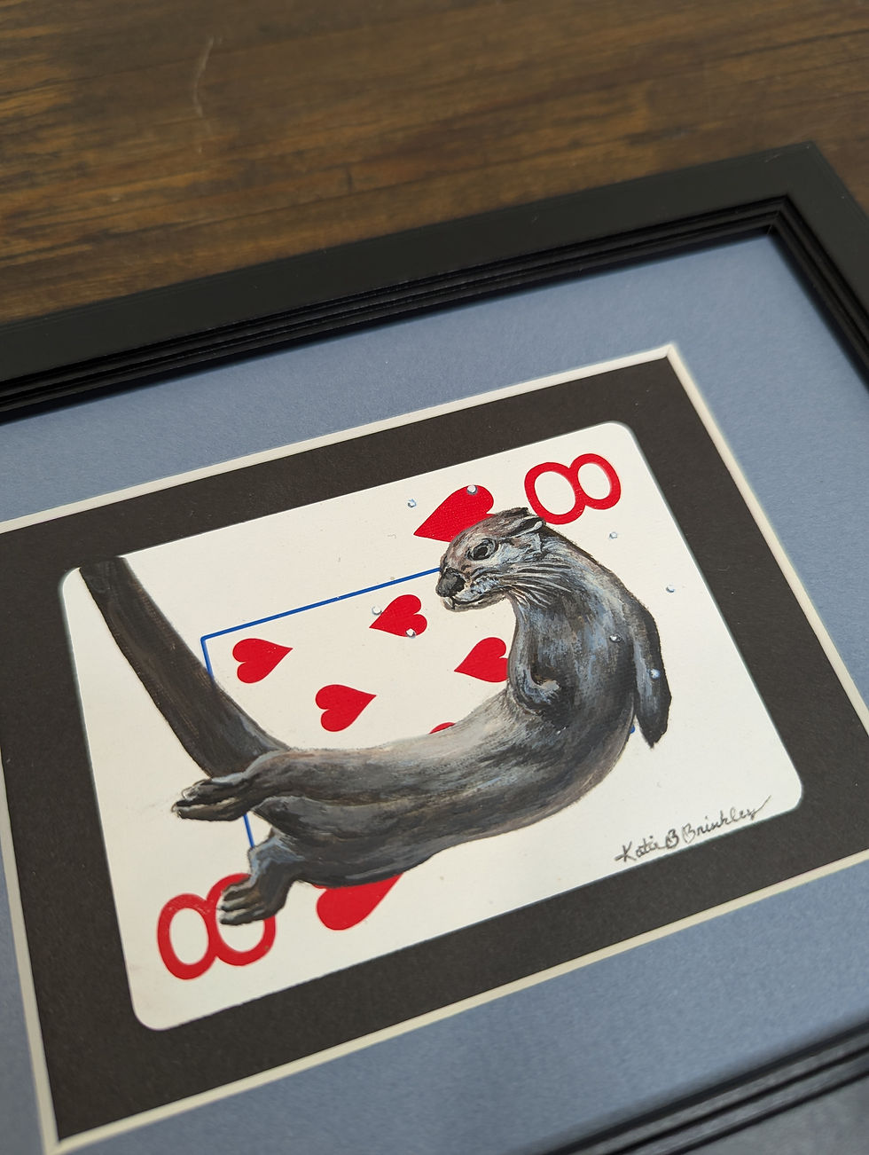 river otter painting on an eight of hearts playing card