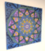 mandala design with feathers and purple flowers