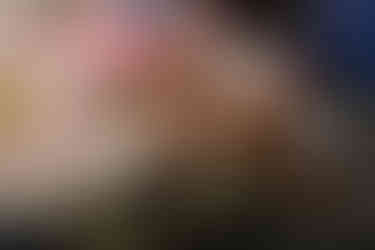 Boy writing, woman pointing out something