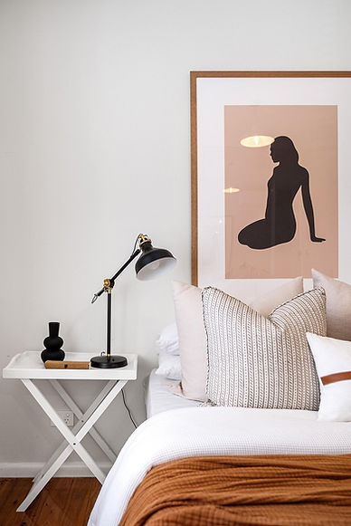 Luxury bedroom with soft lighting, local art, and high-end linens