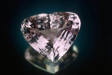 Kunzite gemstones are shades of violet and pink, caused by trace impurities of manganese. This variety of spodumene was first discovered in Pala, California, in 1902, and was later named for the American gemologist George F. Kunz. Generally, the value of kunzite increases with the richness of color. Kunzite gems must be cut relatively large to show a strong body color; small stones typically appear very light pink at best. Some kunzites fade in color upon exposure to light and can turn almost colorless. Consequently kunzite is known as an “evening stone,” and should not be exposed for long periods to bright light, especially sunlight. This 880ct heart-shaped kunzite is from Brazil. The major sources of kunzite are Brazil, Afghanistan, Madagascar, and California.
