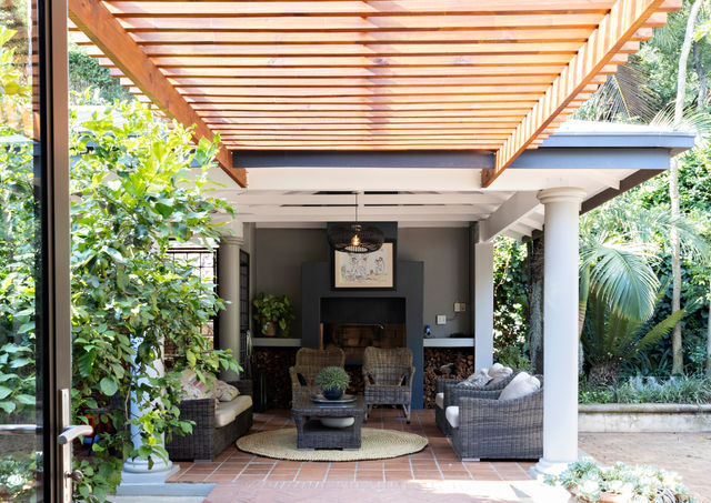pergola walkway joining patio to house with herring bone piazza pavers