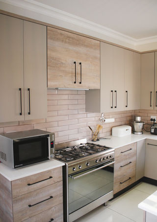 Kitchen with gas stove and white subway tile splashback