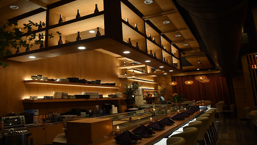 Sushi restaurant interior, bar with seating and shelves in background, Sushi Ginza.