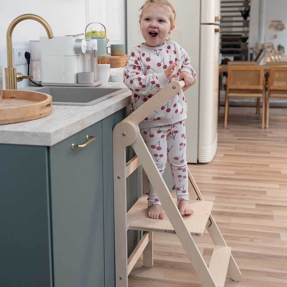 Child Using the CLIFF Montessori Learning Tower in the Kitchen
