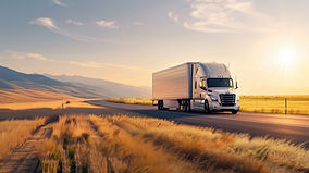 A tractor trailer traveling through the country to make deliveries.