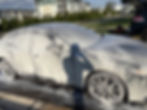 Professional mobile detailing foam wash on a car outdoors