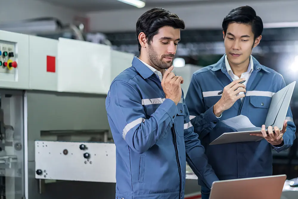 male-asian-caucasian-engineer-professional-having-discussion-standing-consult-machine-fact