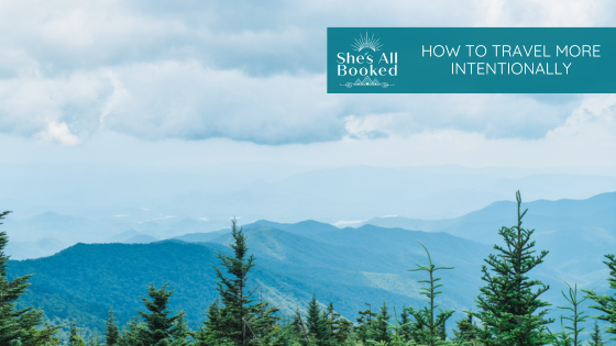 view of the mountains with blue sky and blog title: how to travel more intentionally