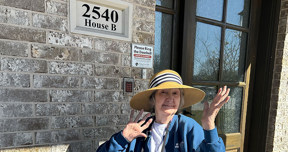 Senior resident standing outside a residential-style assisted living home at Mustang Creek Estates offering affordable assisted living and memory care in a warm neighborhood setting.