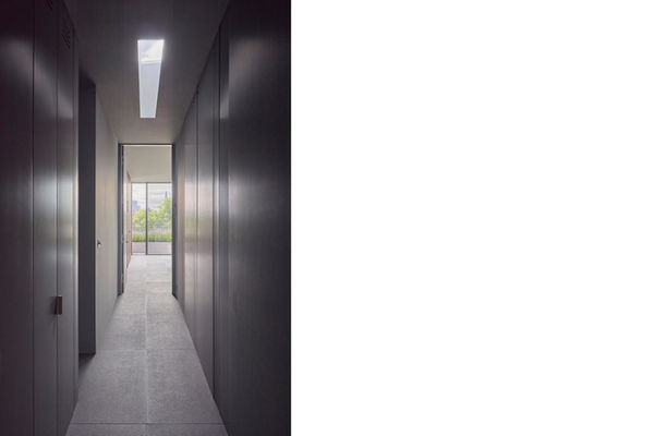 Looking down the hall at Clerkenwell Rooftop towards the open-plan living space, with the City of London skyline beyond.