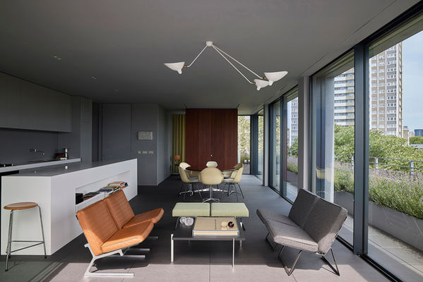Open-plan living, dining and kitchen space at Clerkenwell Rooftop, with the sliding timber-clad monolith visible in the background.
