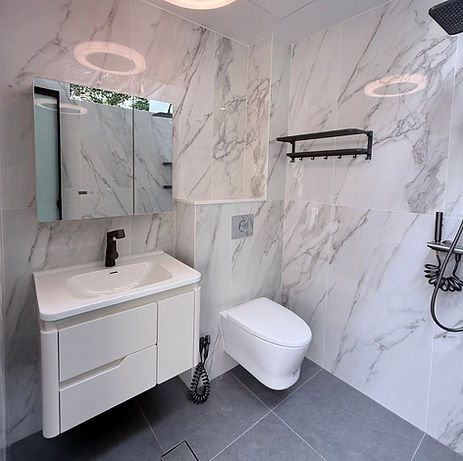 Space-saving white bathroom vanity and mirrored medicine cabinet with internal storage for Singapore condo renovation by Cosmos Decor.