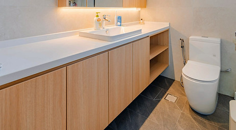 Modern minimalist bathroom renovation project by Cosmos Decor showing professional tiling and long custom-made vanity cabinet.