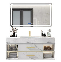 Minimalist white marble bathroom cabinet with gold trim and open storage for a clean, airy look.