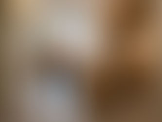 A modern Singapore HDB flat living room and kitchen designed by Cosmos Decor, featuring "Invisible Accessibility" with curved wood cabinetry, wider walkways, and non-slip grey tiles. An elderly woman and a younger woman interact in the warm, Japandi-style multi-generational space.