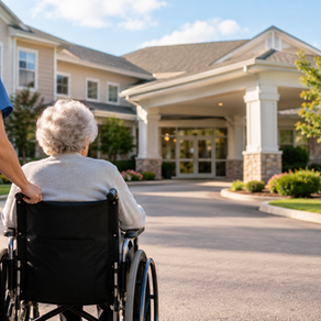 Older adult in a wheelchair being assisted by a caregiver outside a nursing home in Pennsylvania.